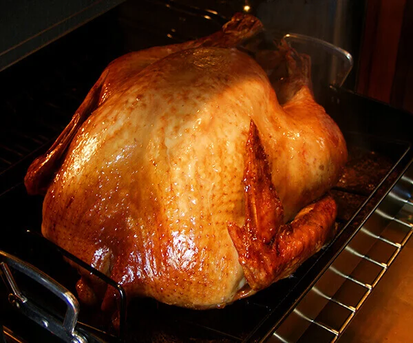 Whole turkey in an oven.