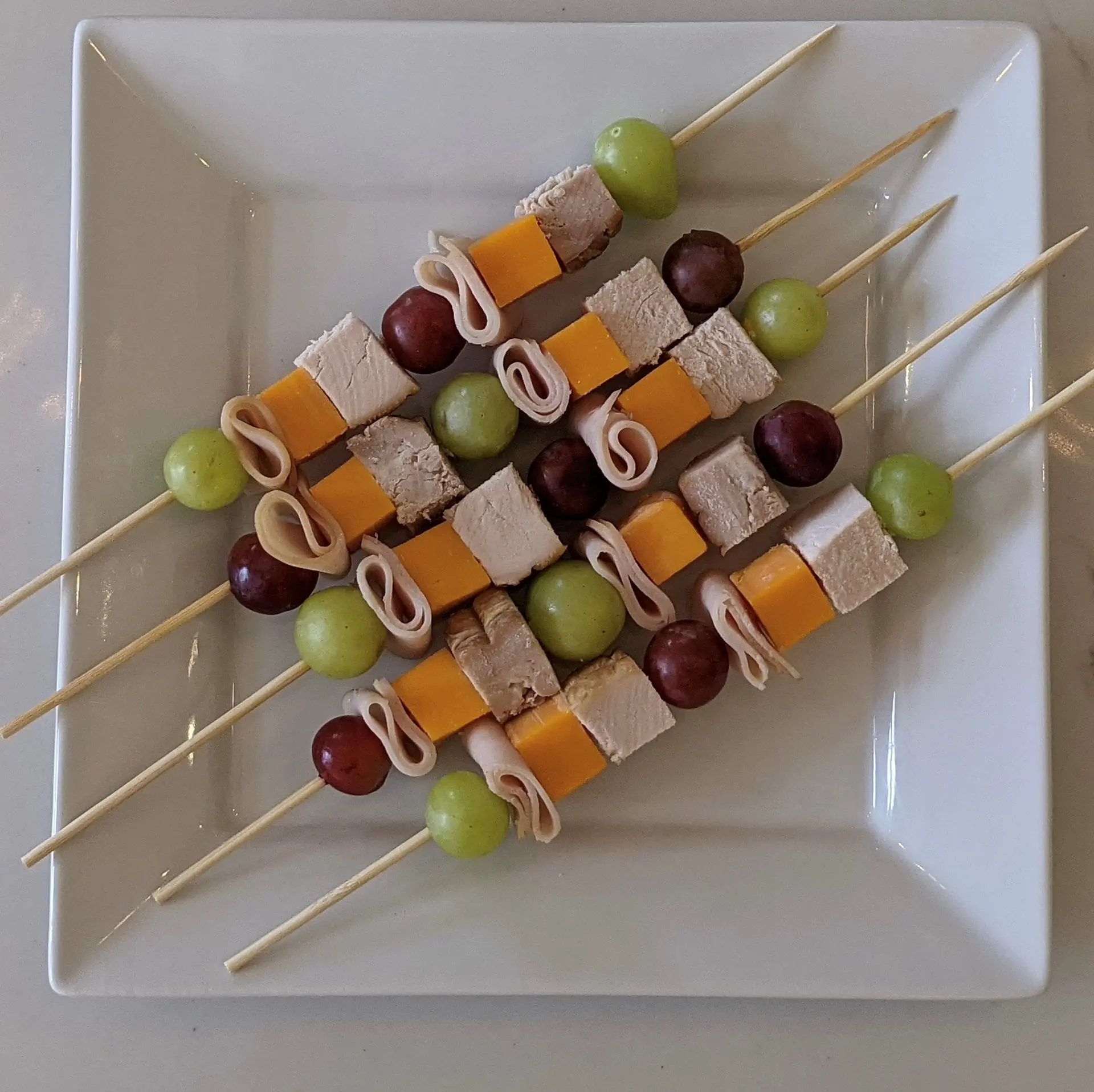 School lunch skewers made with fruits and turkey ham.