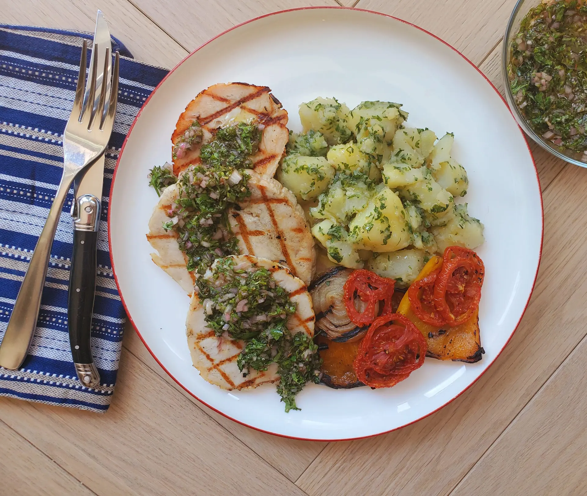 Turkey steaks with chimichurri sauce, grilled vegetables and potatoes.