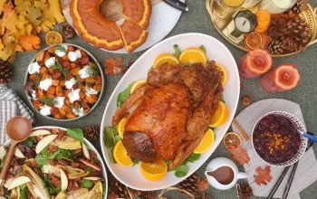 A Thanksgiving feast spread out on a table, featuring a roasted turkey, assorted vegetables, and other delicious foods.