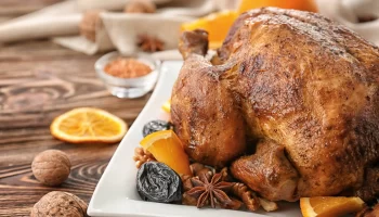 Thanksgiving whole turkey with orange, spices and dry fruits.