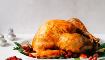 Roasted whole turkey with fruits and cranberry chutney.