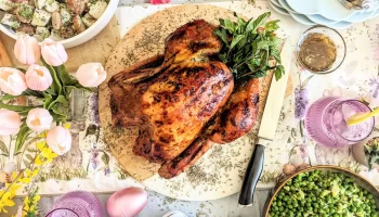 Butterball whole turkey on a wooden plate with side salads