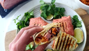 Turkey bacon wrap with cilantro and lemon placed on the table.