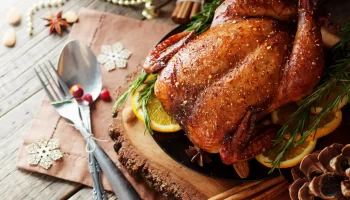 Christmas whole turkey rubbed with spice with lemon and cherries.